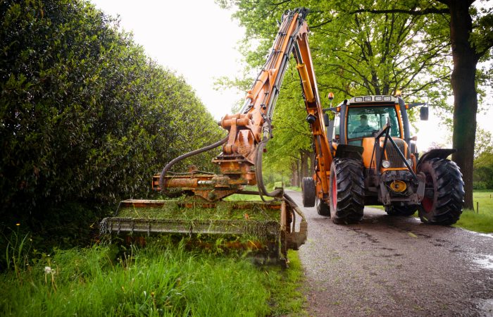 mowing grass shoulder with tractor