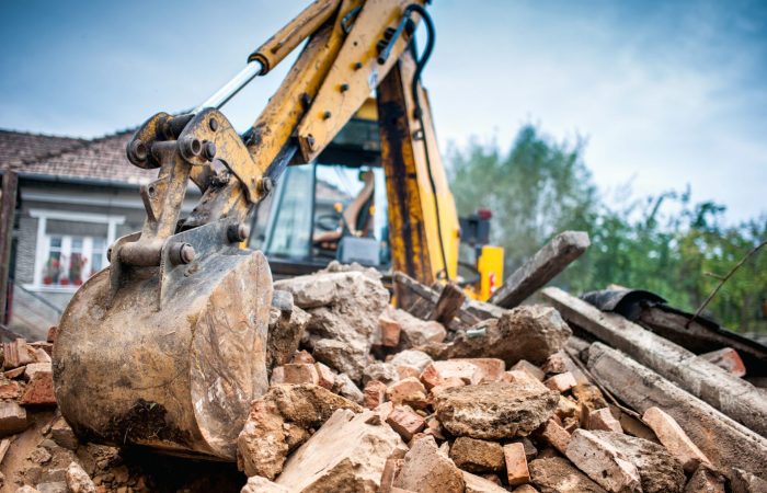 Hydraulic crusher excavator backoe machinery working on site demolition